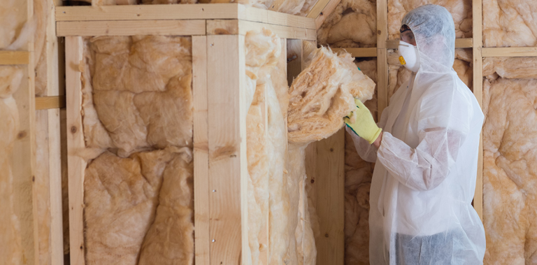 Man installing cavity wall insulation